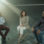 A multicultural group of people participating in a supportive therapy session indoors, fostering diversity and discussion.